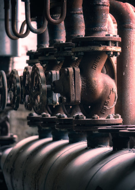 Row of industrial pipes with control valves