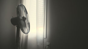A bedroom fan cooling down a hot sleeper.