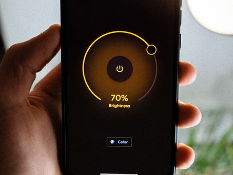Smart home mobile device controlling lighting brightness in a modern living room