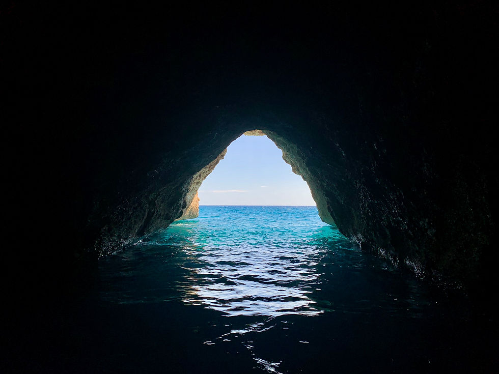 View from inside to outside the cave half filled with water, view on the Ocean
