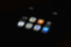 Close-up of a smartphone screen displaying various AI-related app icons, including Character.AI, Copilot, Claude, Perplexity, Gemini, ChatGPT, DeepSeek, and the App Store. The screen is set against a dark background, with the time 8:33 and a strong network signal visible at the top.