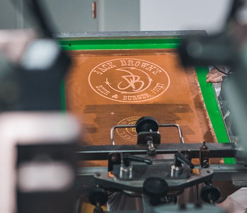 Wholesale screen printing in Utah - Pro Ink production team printing large apparel orders for resellers