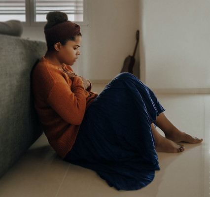Woman sitting on floor anxious, what she was like prior to IFS therapy