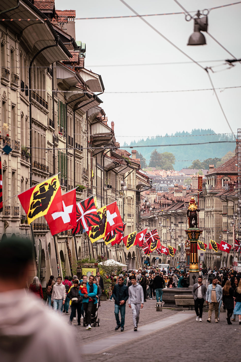 Historic Zytglogge clock tower in Bern old town decorated with Swiss flags for National Day