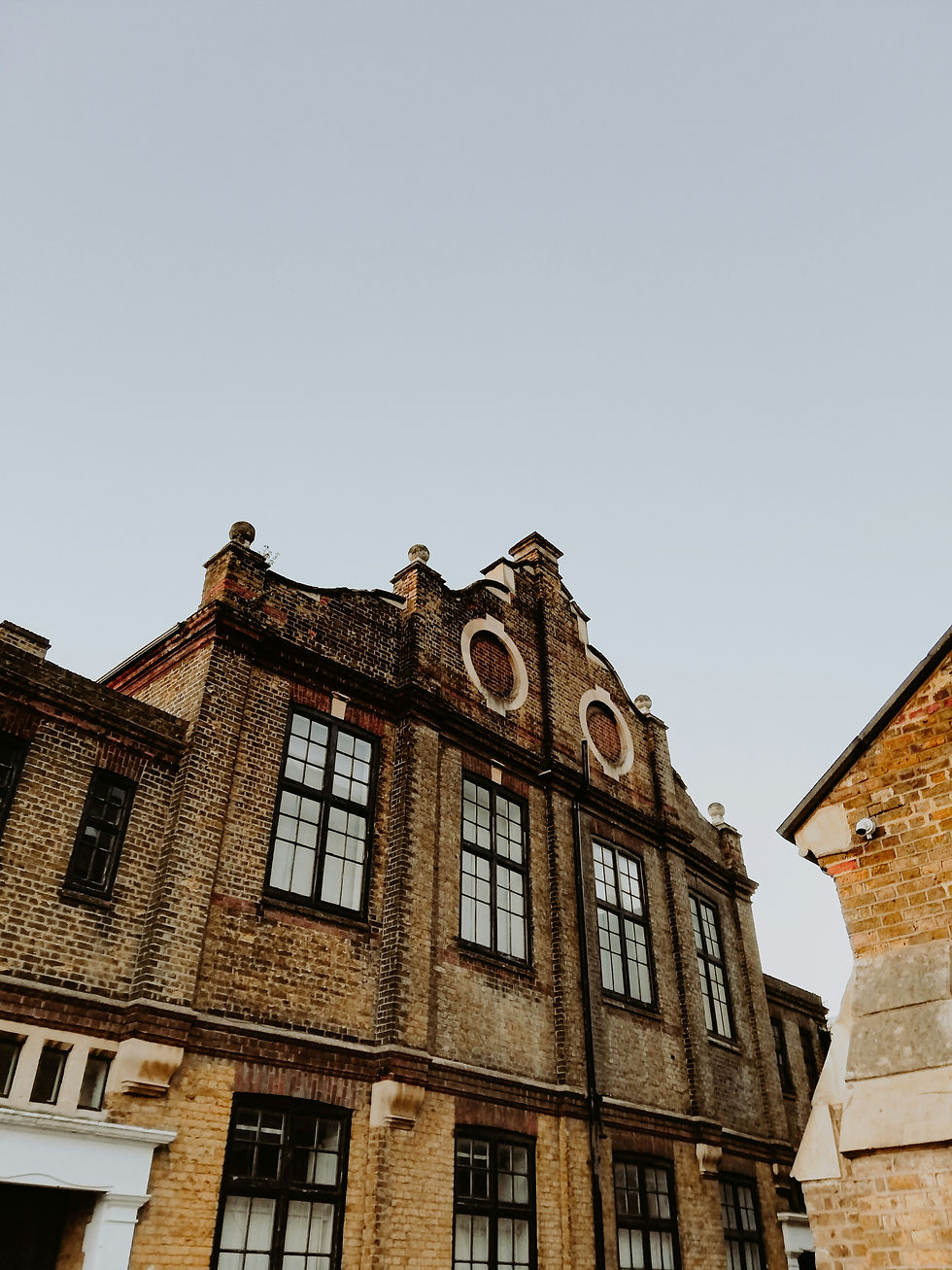 Façade of a historic brick building with ornate gables