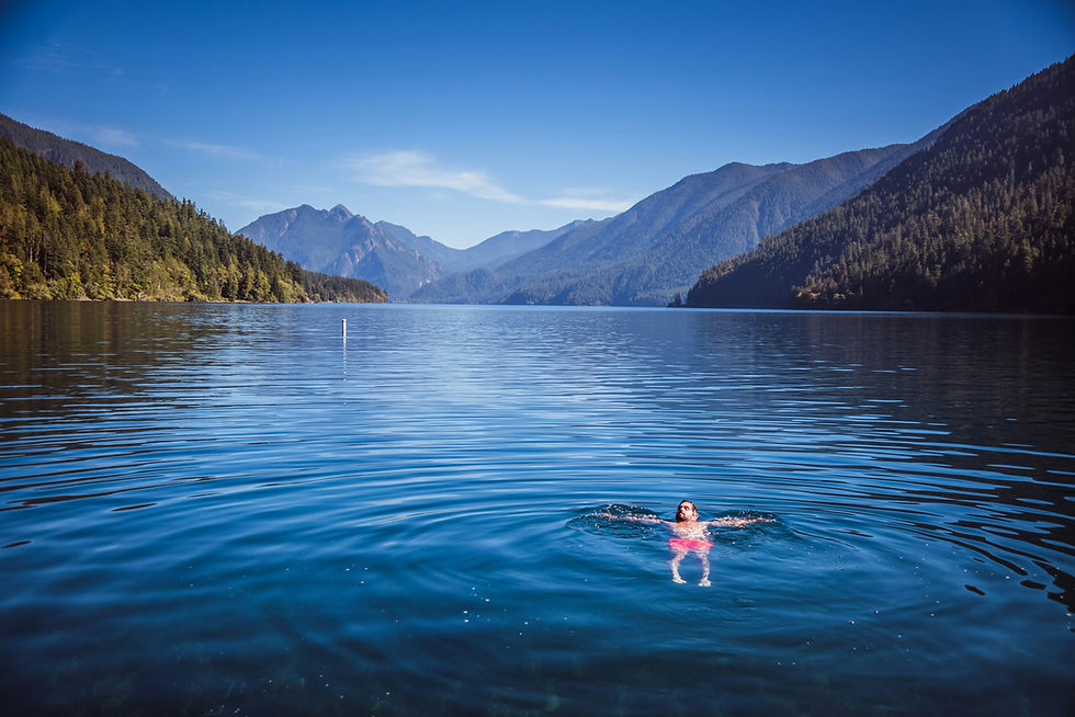Person floating in Lake Crescent near Port Angeles, WA.