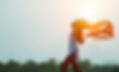A woman waving a scarf in the wind to symbolize freedom
