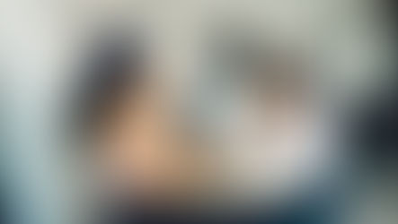 Women sitting at a coffee shop. One is stressed on is laughing.