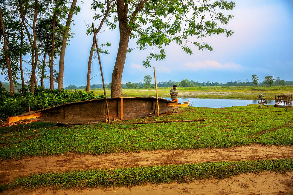 Serene sunset over a calm river with vibrant orange and yellow hues reflecting on the water. Silhouetted banks create a peaceful scene.
