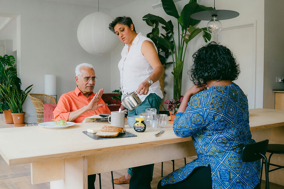 A caregiver serving tea at the table during a home visit
