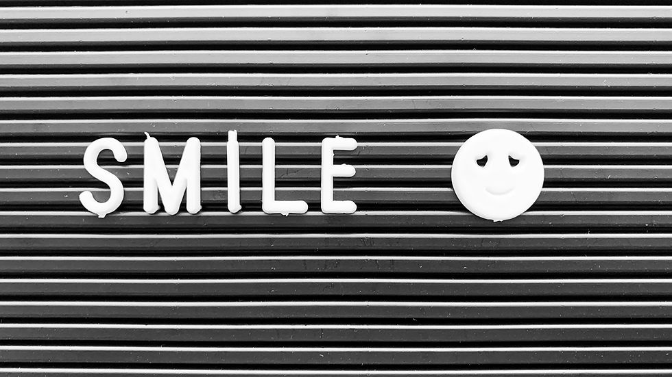 Sign displaying the word ‘Smile’ beside a face with no smile, representing hidden depression, emotional numbness, masking emotions, loneliness, and struggling behind appearances.