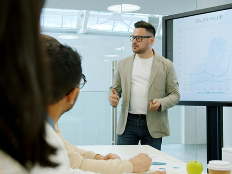 Colleague presenting to the team during a business meeting