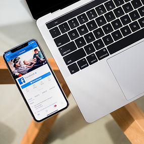 Facebook open on phone and laptop to promote sharing #DanOlesenWard1 on social media