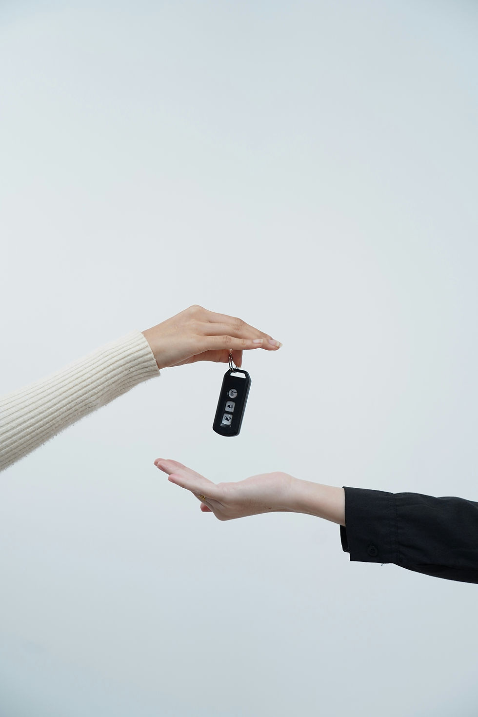 Hands exchanging keys representing ownership and licensing structures under intellectual property law