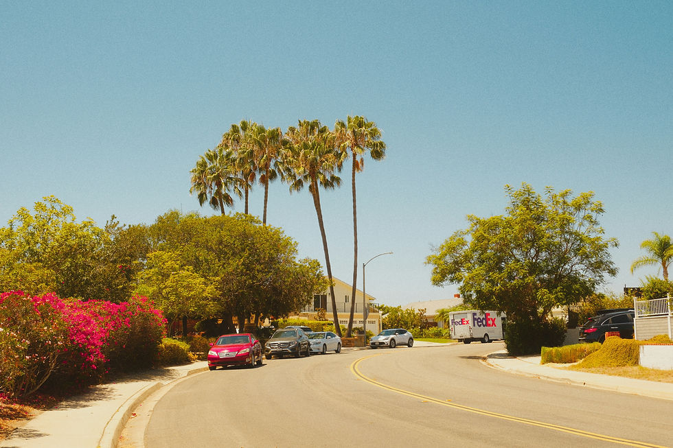 Shaded street next to an unshaded asphalt parking lot on a hot day, illustrating the urban heat island effect | Gasilov Group 2026