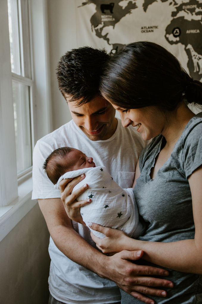 Newborn Photography by Blake Ferguson depicts a Happy Couple Joined by their Baby in Ontario, Canada.