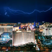 Las Vegas Strip on a rainy winter day with lightings in the sky and people wearing jackets