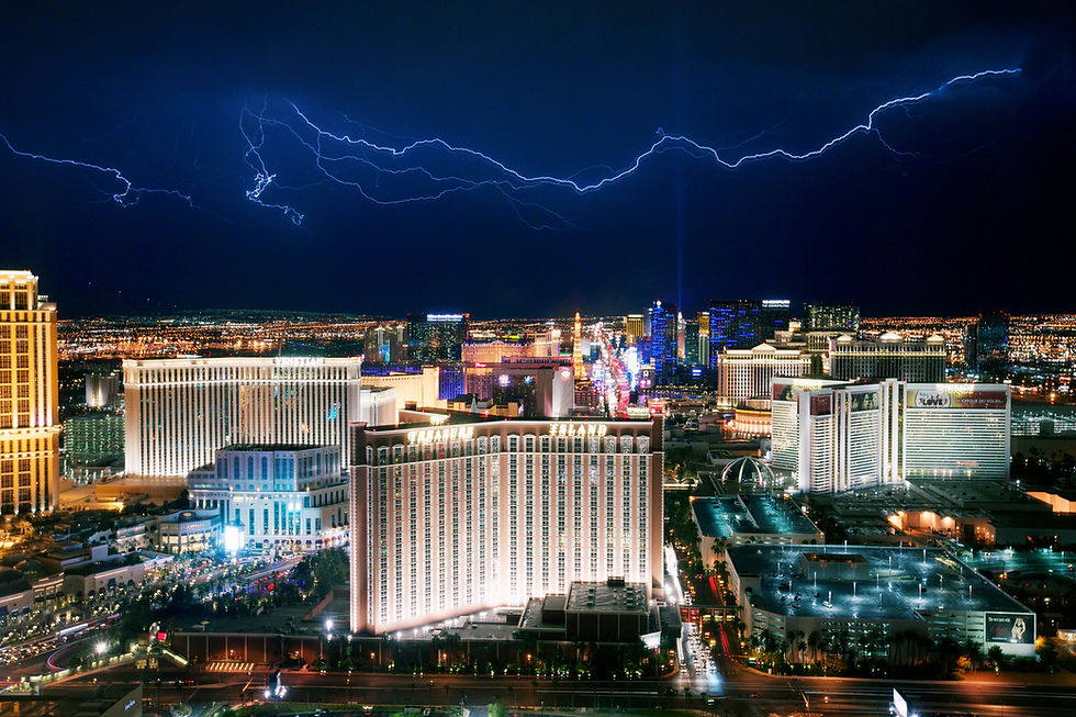 Las Vegas Strip on a rainy winter day with lightings in the sky and people wearing jackets