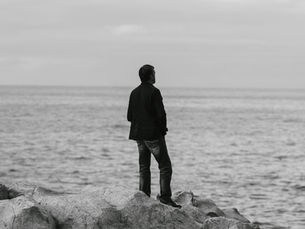 Man staring out at an ocean