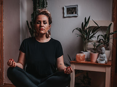 Woman sitting on floor meditating