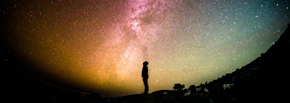 Man looking into the universe contemplating his existence