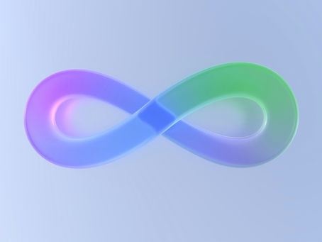 Photo of a colorful infinity symbol against a plain neutral background.
