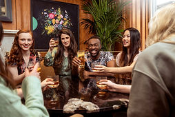 A group of people gather at a bar.
