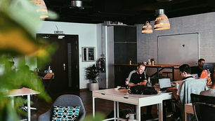 Creative agency team reviewing a monthly content calendar and client project schedule.