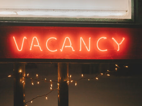 A red neon light spelling out the word vacancy