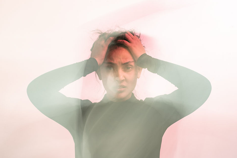 A woman holding her head in confusion