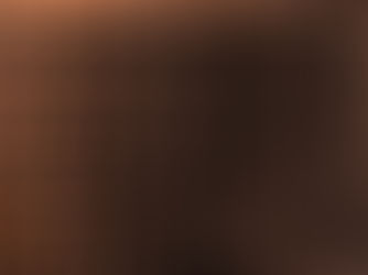 Abstract orange-and-black glitch pattern of dense vertical and horizontal lines, with no clear subject or text visible.