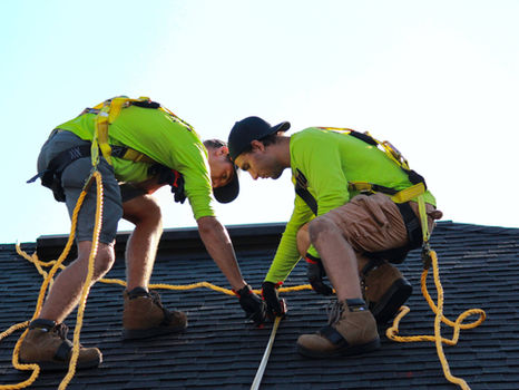 Two men working on a roof