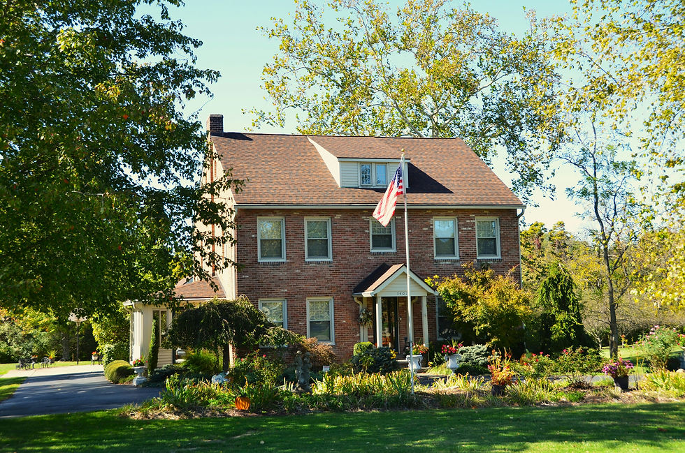 Family home with a green lawn and shade trees