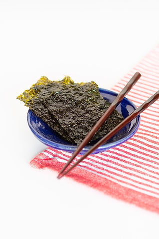 dried nori sheets on table with chopsticks