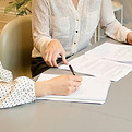 Two people completing paper work