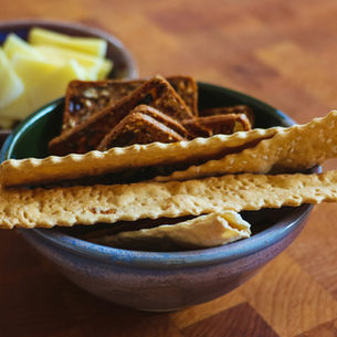 Crackers and cheese in bowls, showing low-effort meal options for ADHD adults.