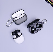 Wireless earbuds resting in their charging cases