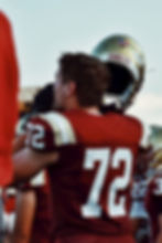 Football player taking off his helmet