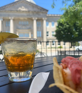 Enjoy a selection of craft drinks and top-shelf spirits at 1830 Chophouse, with the historic Boone County Courthouse gracing the background. This unique setting offers a perfect blend of refined taste and local charm, making every sip a memorable experience in Lebanon, IN.